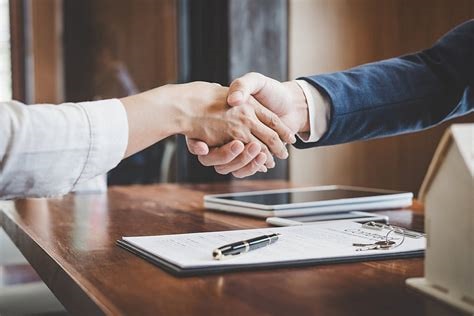 Business handshake across a desk