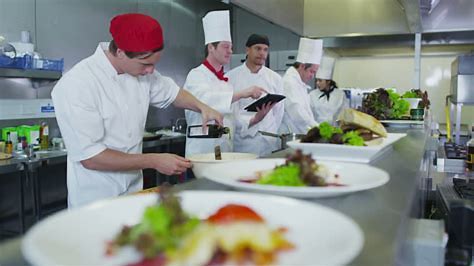 Chefs plating in a commercial kitchen